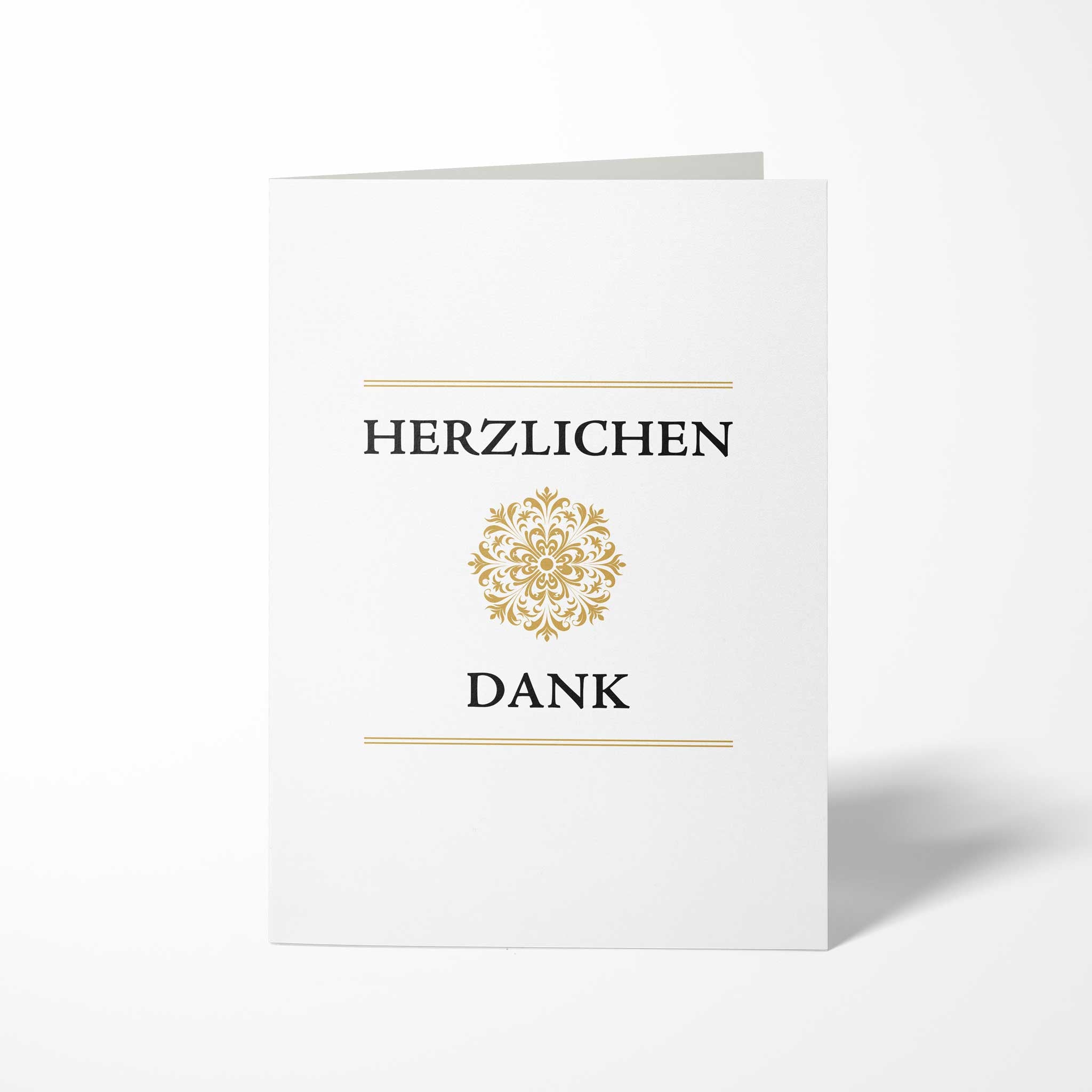 Vorderansicht der hochkant gefalteten B6 Dankeskarte mit einem zentrierten, kreisrunden Goldornament zwischen den schwarzen Schriftzügen HERZLICHEN und DANK.