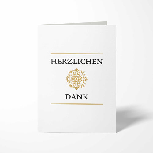 Vorderansicht der hochkant gefalteten B6 Dankeskarte mit einem zentrierten, kreisrunden Goldornament zwischen den schwarzen Schriftzügen HERZLICHEN und DANK.