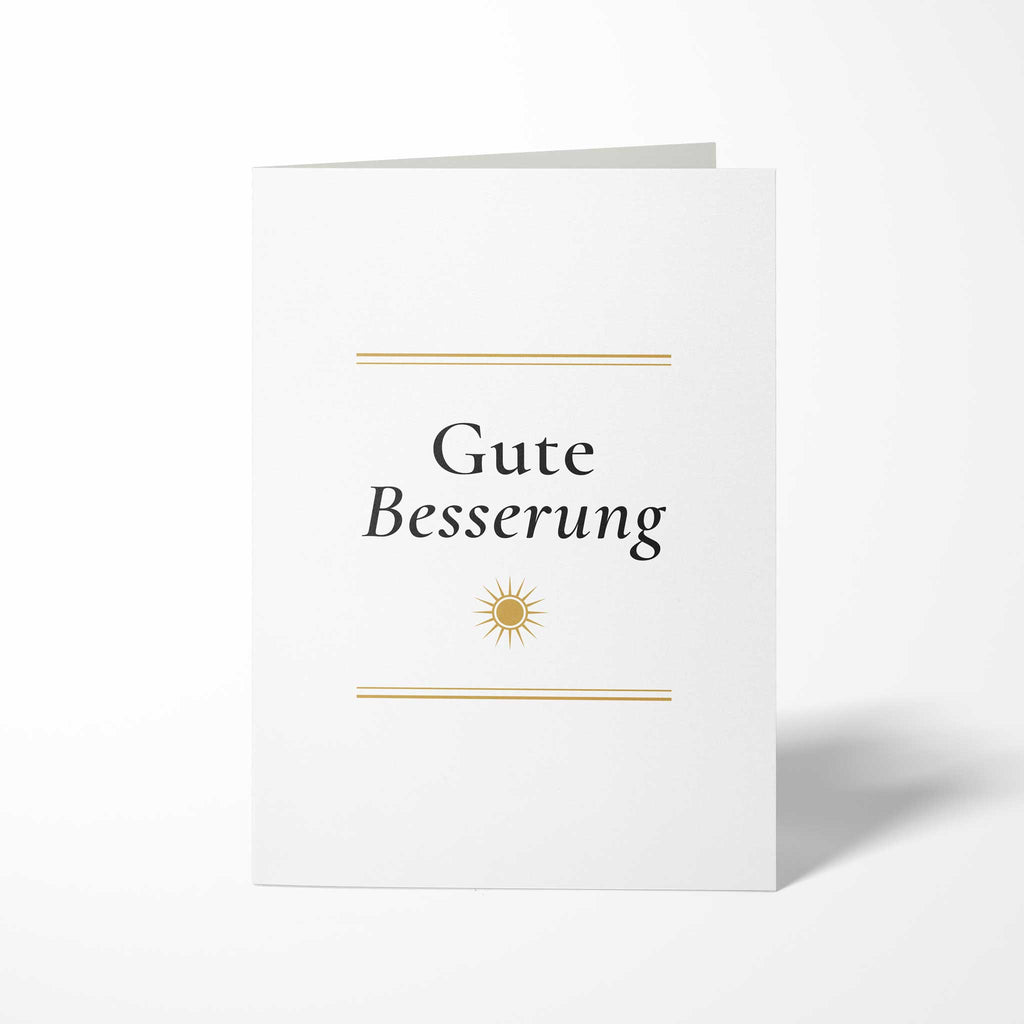 Vorderansicht der hochkant gefalteten B6 Genesungskarte mit dem Schriftzug Gute Besserung, einer stilisierten goldenen Sonne und feinen doppelten Goldlinien.
